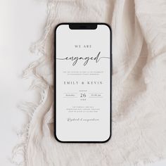 an iphone case that says we are engaged on the front and back, next to a white blanket