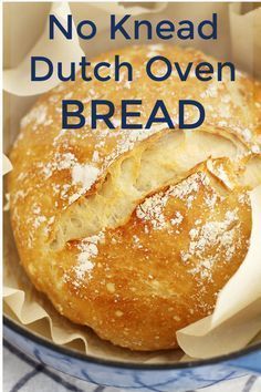 a loaf of bread sitting on top of a blue and white plate with the words no knead dutch oven bread