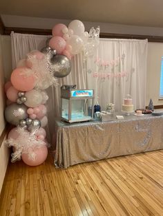 a table with balloons and cake on it