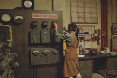 a woman standing next to a machine in a room