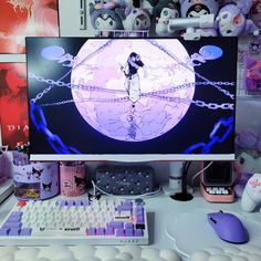 a computer monitor sitting on top of a white desk next to a keyboard and mouse