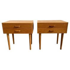 two wooden nightstands side by side with drawers on each end and one drawer open