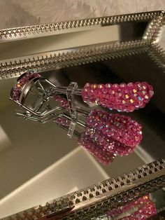 a mirror that has some pink beads on it