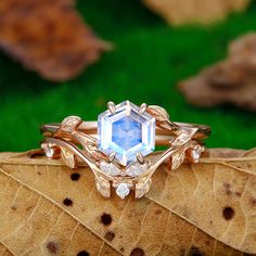 a close up of a ring on top of a leaf