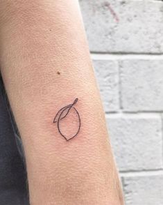 a small tattoo on the arm of a person with a single line drawing of a leaf