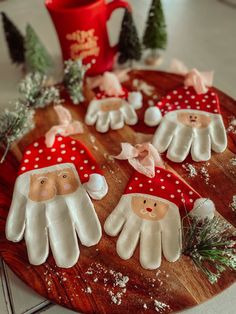 christmas decorations made to look like santas on a cutting board with coffee mug in the background