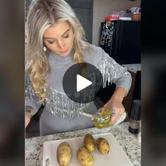 a woman in grey sweater pouring olive into potatoes