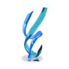 a blue glass sculpture sitting on top of a white table