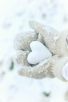 a person holding a white heart in their hand with the words winter wonderland written on it