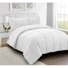 a white comforter set in a bedroom