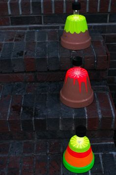 three different colored lights sitting on top of brick steps