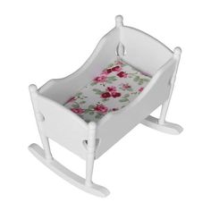 a white rocking toy with pink flowers on it's seat cover and foot rest