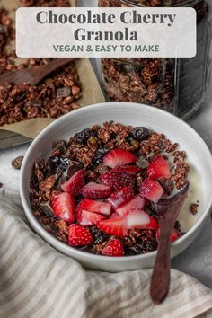 chocolate cherry granola in a bowl with strawberries and yogurt on the side