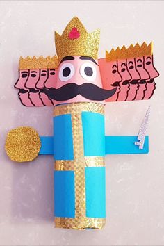 an origami nutcracker made out of toilet paper and gold glitters