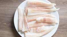 raw fish fillets on a white plate