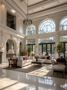 a large living room with high ceilings and lots of windows