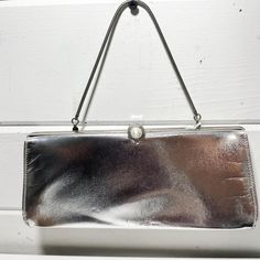 Vintage Silver Metallic Clutch Handbag | Evening Formal Bag Measurements- see pictures! *This item is in pre-owned, vintage condition. All of our items have a past life. We report damage when we notice it but please understand that these items are passed along and that is why we love them. While I've checked it and have listed all details here, there may be an imperfection here or there due to its age. WE DO NOT ACCEPT RETURNS.  *Due to differences in screen settings, colors may slightly differ between photos and physical product. Message me with any questions! Vintage Rectangular Bags For Vintage Events, Vintage Rectangular Bags For Events, Vintage Rectangular Party Bag, Rectangular Retro Shoulder Bag For Vintage Events, Retro Rectangular Shoulder Bag For Vintage Events, Vintage Silver Rectangular Clutch, Vintage Satchel Evening Bag For Parties, Vintage Rectangular Shoulder Bag With Removable Pouch, Vintage Handheld Bag For Party