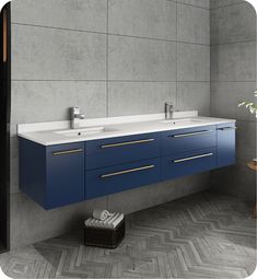 a bathroom vanity with two sinks and blue cabinetry against a gray wall, next to a plant in a wicker basket