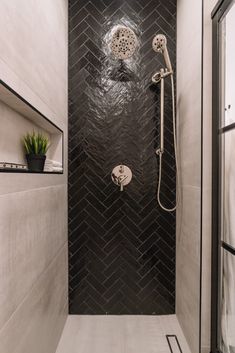 a bathroom with a shower head and hand held shower faucet in the corner