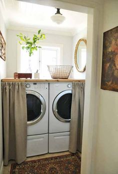 a washer and dryer sitting in a room next to each other on top of a rug