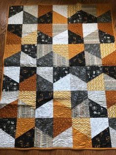 This cute baby quilt is made using Safari Life fabric from Moda in black, tan and gold.  It is machine quilted in an allover pattern and is backed in a black and gold batik. Quilt measures approximately 41 x 52 and would make a great gift! Hospice Gifts, Safari Baby Quilt, Brown Quilts, Beginner Quilts, Warm Bodies, Block Quilts, Black And White Quilts, White Quilts, Musical Theme