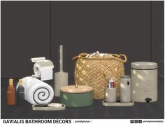 several bathroom items are arranged on the floor in front of a basket and toilet paper