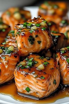 the salmon is covered in sauce and garnished with green onions