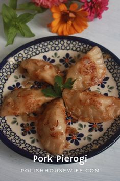 some food is on a blue and white plate with flowers in the backgroud