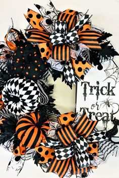 a halloween wreath with black and orange decorations