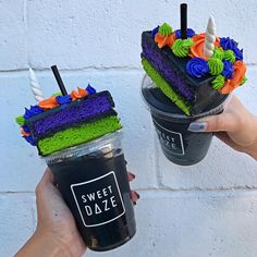 two people holding up cups with cake on them and one has a drink in it