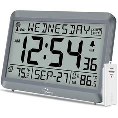 an alarm clock with thermometer on display