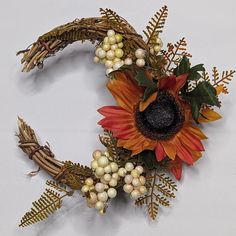 a sunflower wreath with berries and leaves