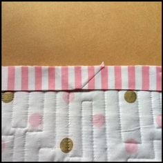 pink and white polka dot fabric with gold dots on the bottom, along with an orange strip