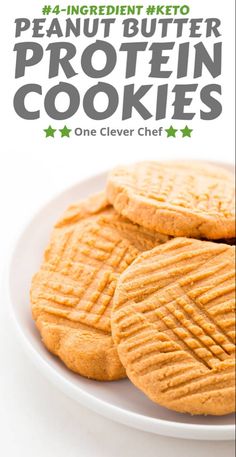 four peanut butter protein cookies on a white plate with the words, one clever chef