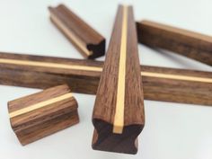 several pieces of wood sitting on top of a white table next to some smaller ones