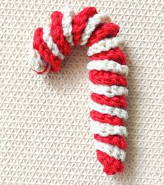 a red and white candy cane laying on top of a table