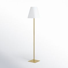 a gold floor lamp with a white shade on the base and a light bulb at the end