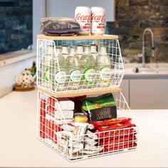 two tiered storage rack filled with drinks and snacks on top of a kitchen counter