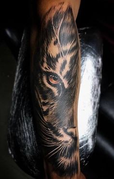 a man with a tiger tattoo on his arm