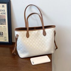 • White Shoulder Bag With Mobile Phone Pocket For Errands, Casual Beige Phone Bag For Travel, Casual Beige Phone Bag With Large Capacity, Casual Beige Large Capacity Phone Bag, Beige Handheld Phone Bag For Travel, Large Capacity Tote Phone Bag, Large Capacity Tote Phone Bag For Shopping, White Everyday Use Phone Pouch Bag, Trendy Beige Phone Bag For Travel