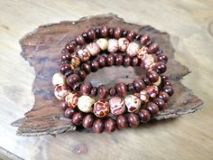 A hand-beaded bracelet was made with care of wooden beads and elastic cord, one bracelet is made of wooden patterned decoupage beads. If you would like a necklace to match, check-out: https://www.etsy.com/uk/listing/657231473/wooden-beaded-necklace-7-8mm-beads https://www.etsy.com/uk/listing/1434797999/wooden-beaded-necklace-5-7mm-beads Measurements (approx.): Bracelet length: 6" (15cm), 7" (18cm) or 8" (20cm) choose your size or request custom order Bead length: (5-10 mm) WHAT IS YOUR SIZE? For Handmade Wooden Beaded Bracelets For Meditation, Brown Wooden Beaded Bracelets With 8mm Beads, Brown Wooden Beads For Bracelets, Brown Wooden Bracelets With Round Beads, Brown Wooden Beaded Bracelet, Wooden Beaded Bracelets With Round Beads, Brown Wooden Beaded Bracelets With Round Beads, Brown Wood Beaded Bracelets With Round Beads, Brown Wooden Beaded Bracelets