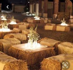 hay bales with flowers and candles on them