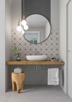 a bathroom with a sink, mirror and stool