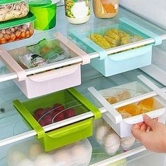 a refrigerator door is open with several containers and food items in the freezer compartment