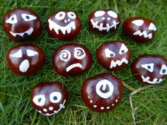 chocolate candies with faces painted on them sitting in the grass