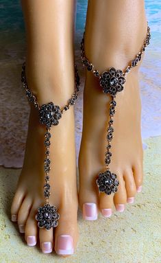 This pair of barefoot sandals features two vintage looking gray crystal flower clusters with linked crystals that stream down the middle of the foot and around the ankle. A size adjustable crystal flower toe ring holds the piece in place on the foot. Each piece detaches at the back of the ankle with a lobster claw latch. They are size adjustable and one size fits most. Comfortable and versatile, it will lend itself to casual or formal events. My barefoot sandals are sold as a pair and one size fits most. All items are made in a smoke free environment. *If there is any issue with your barefoot sandals, please let me know so that I can correct it. Thanks for visiting my shop!👣 Crystal Barefoot Sandals, Barefoot Sandals Beach Wedding, Beach Wedding Sandals Barefoot, Beach Wedding Jewelry, Fairy Shoes, Vintage Wedding Jewelry, Ankle Jewelry, Walking Barefoot, Sandals Beach