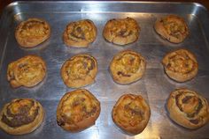 twelve small pastries sitting on top of a metal pan