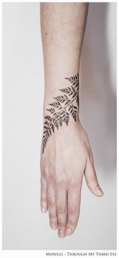 a person's hand with a tattoo on it and the words moguli, art london, united kingdom follow