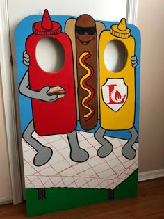 a cardboard cutout of two hot dogs with ketchup and mustard on them