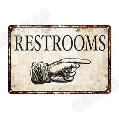 a sign that says restrooms with a hand pointing to the right and an arrow pointing down